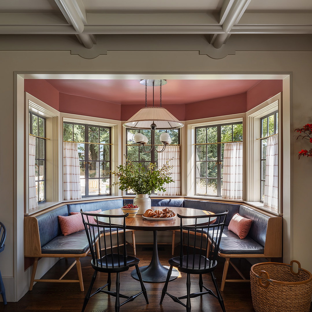 a corner table with four chairs and a bench