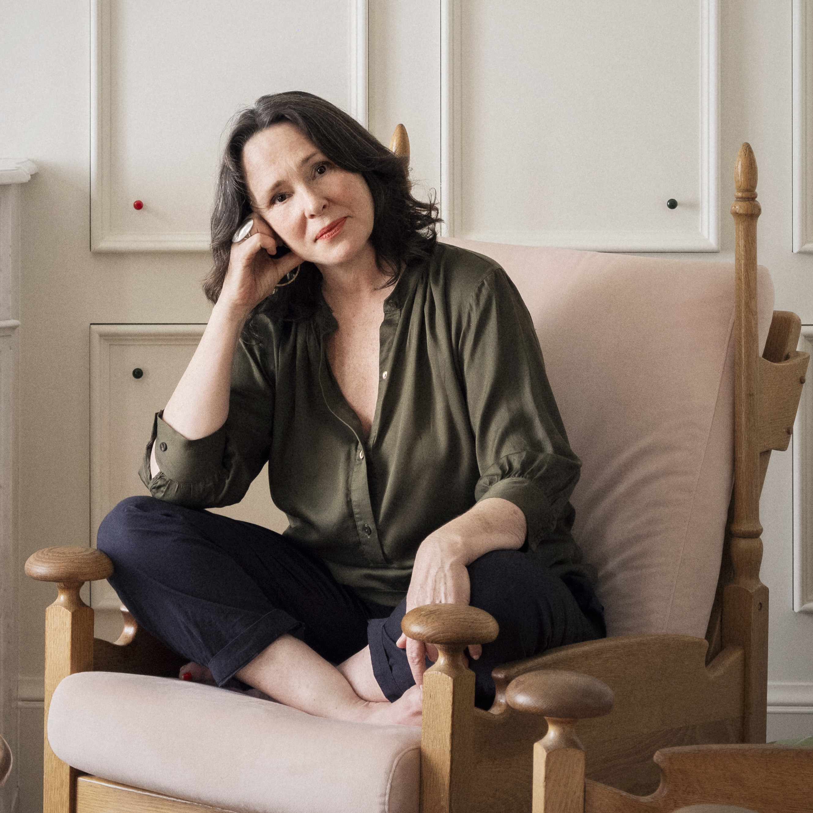 a woman sitting in a chair in a living room