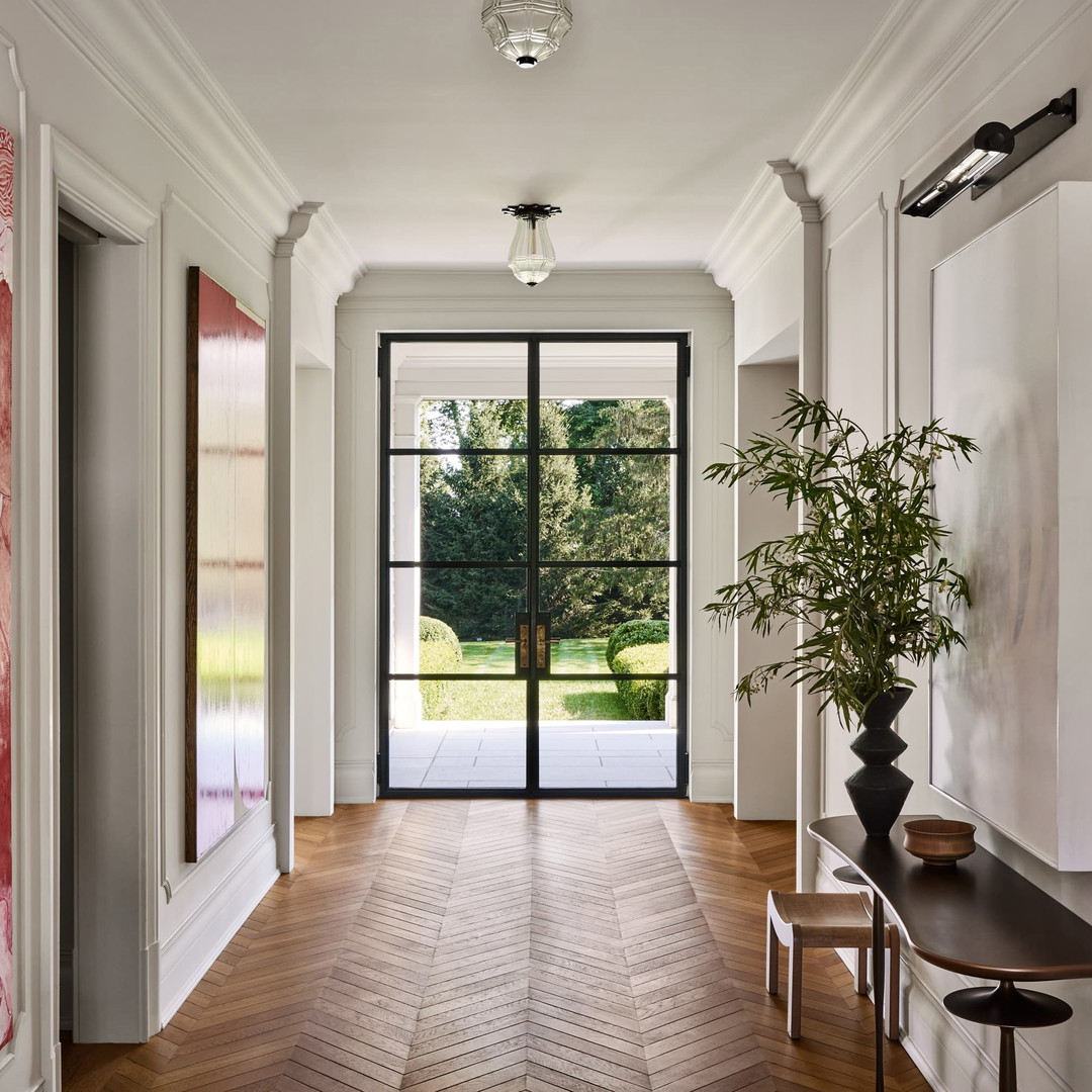 a hallway with a painting on the wall and a bench