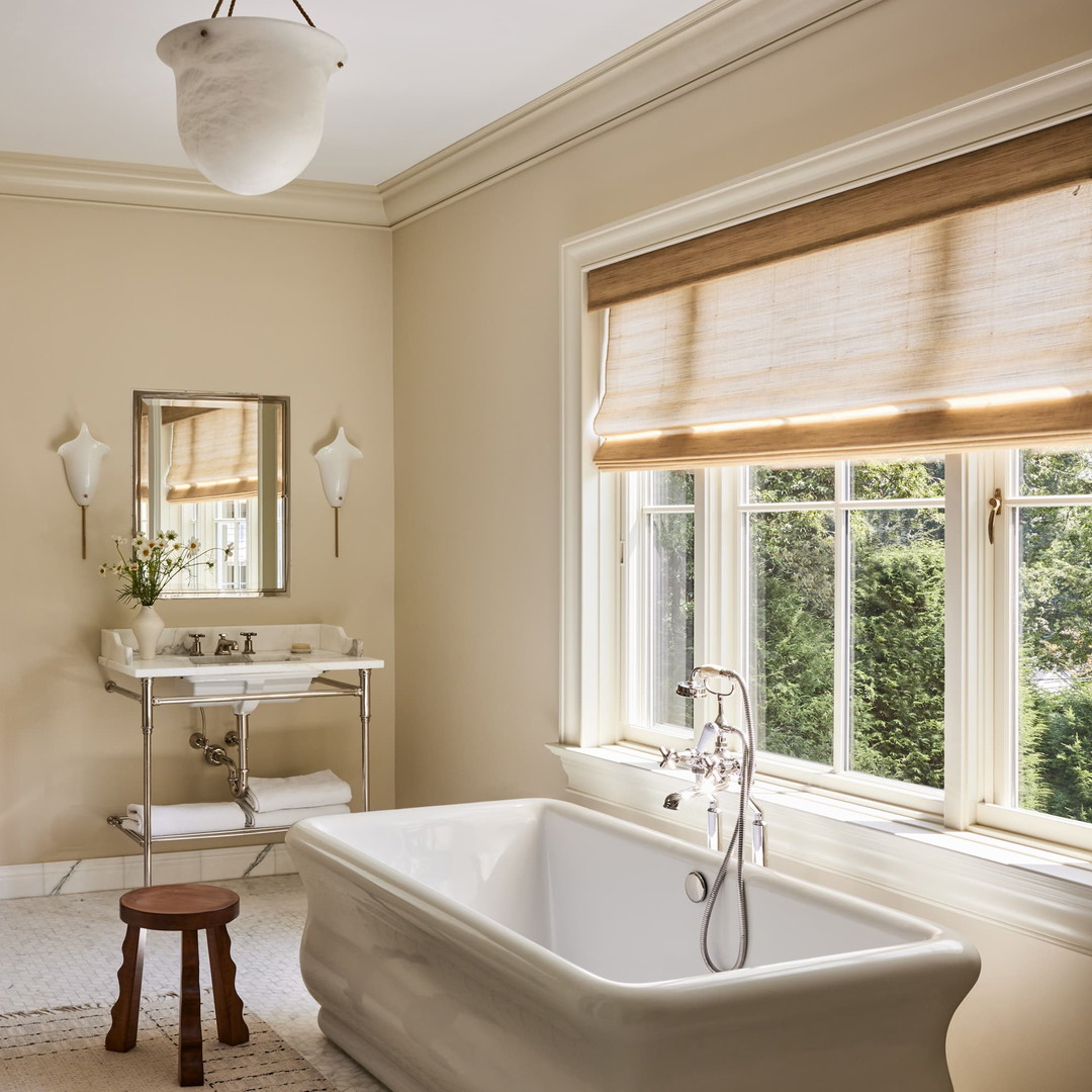 a bathroom with a large tub and a sink