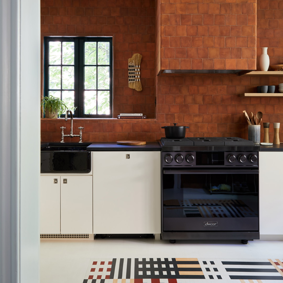 a kitchen with a black stove top oven