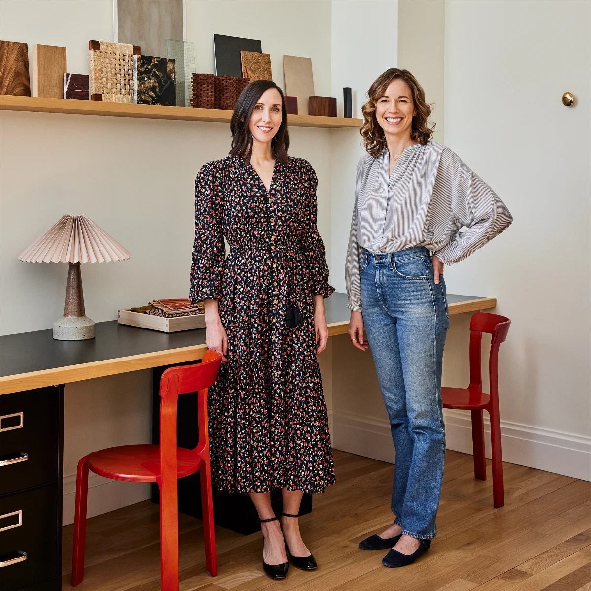 two women standing next to each other in a room