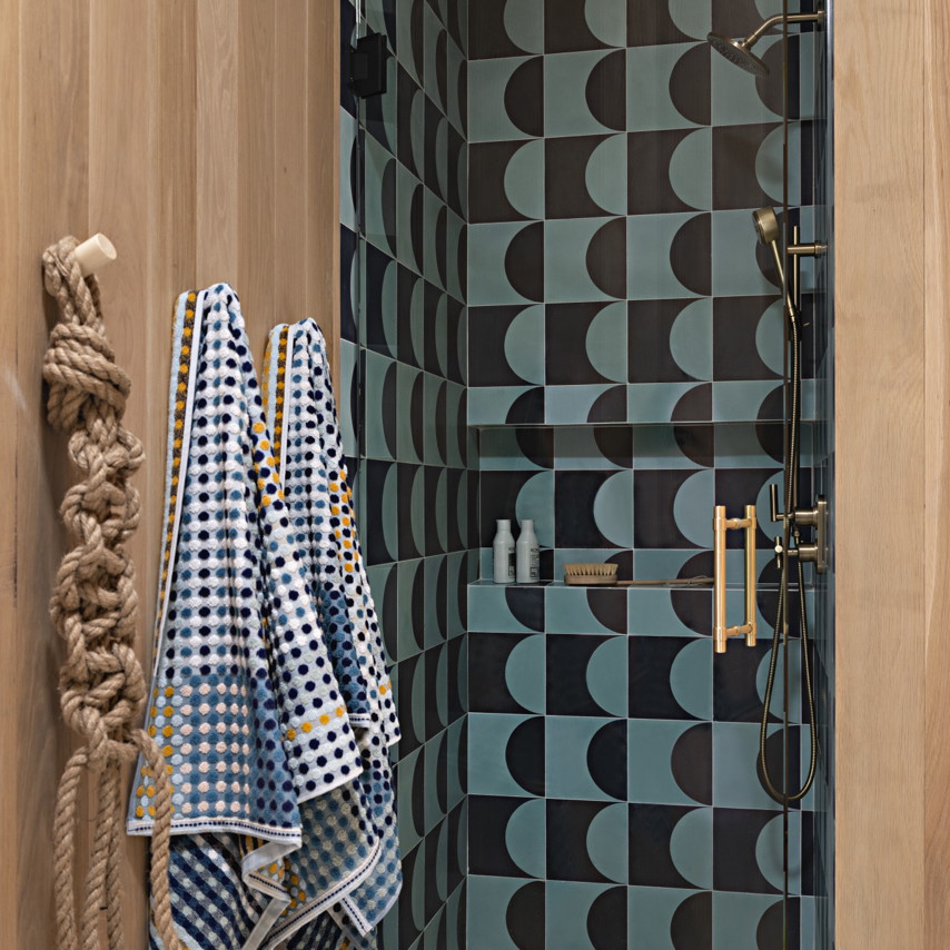 a bathroom with a shower and a towel rack