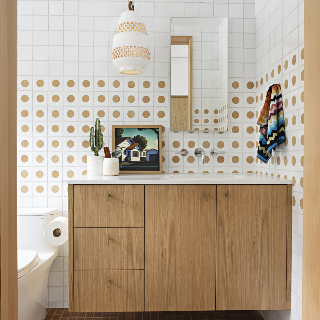 a bathroom with a sink, toilet and a mirror