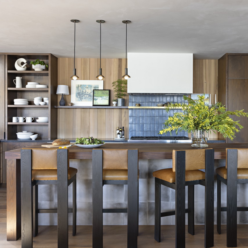 a kitchen with a center island surrounded by wooden cabinets