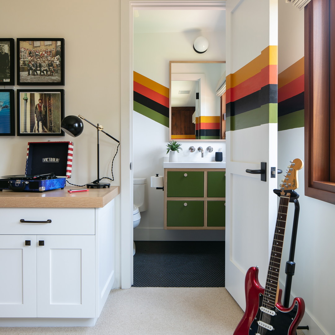 a room with a guitar and a sink