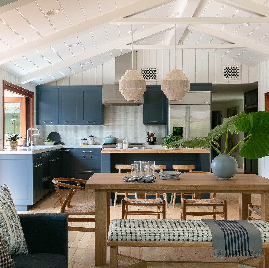 a kitchen and dining room with a table and chairs