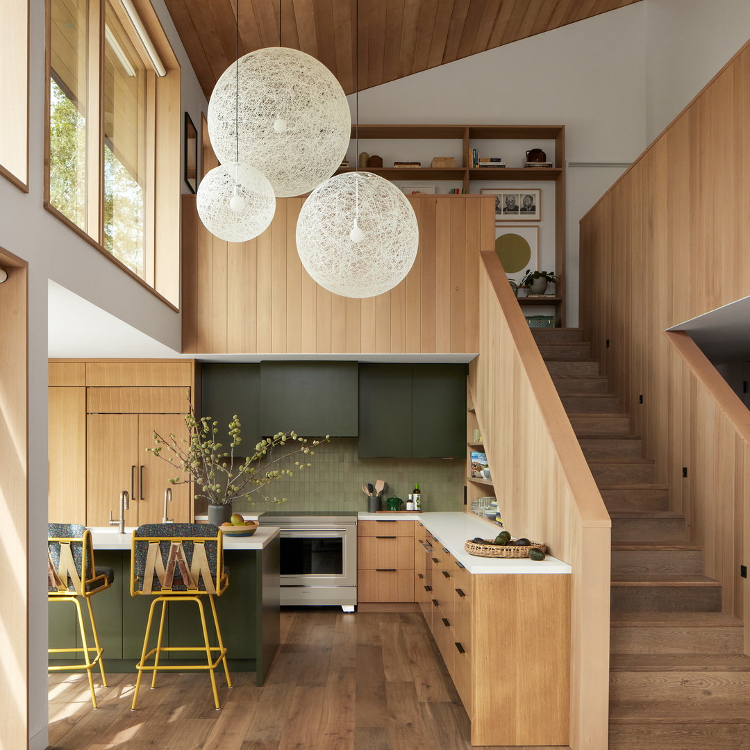 a kitchen with wooden floors and a staircase