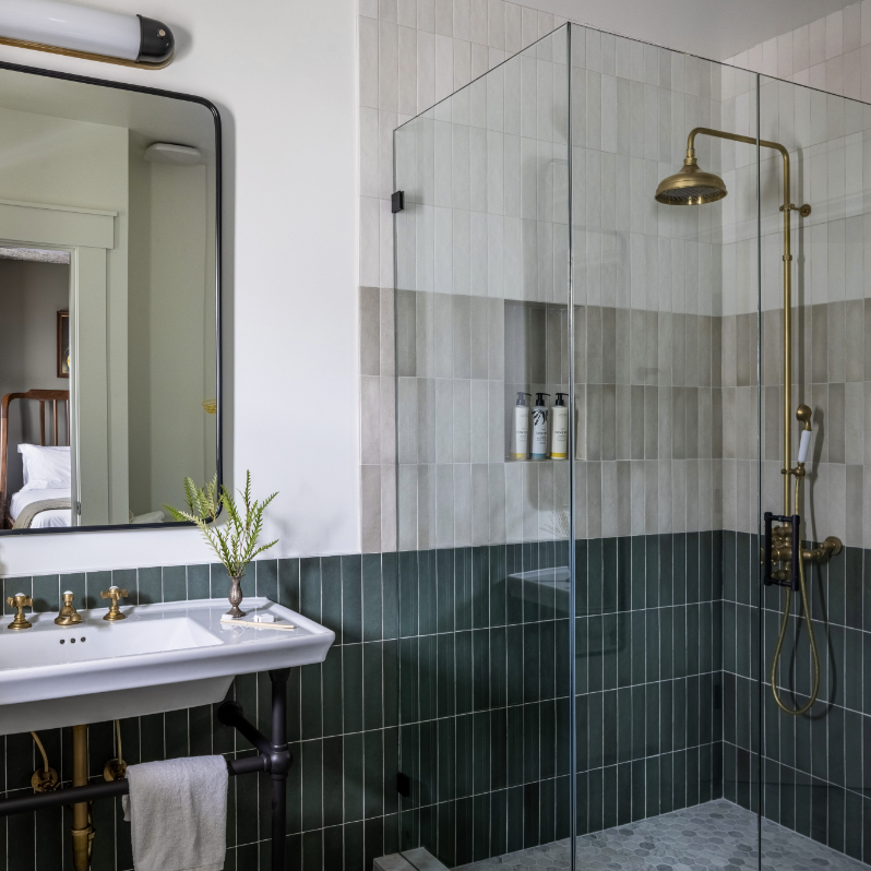 a bathroom with a walk in shower next to a sink