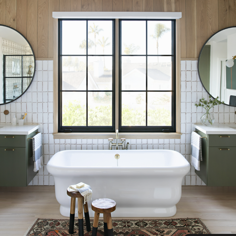 a large white bath tub sitting under a window