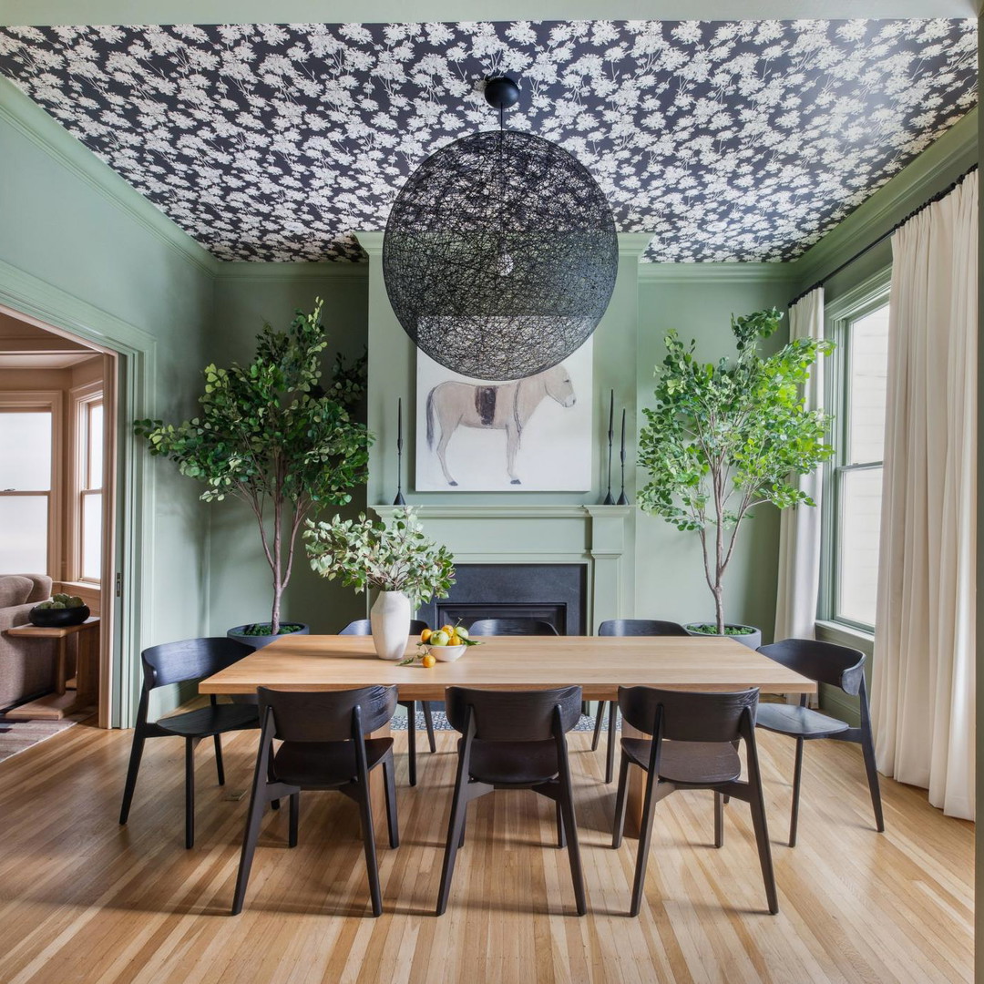 a dining room with a wooden table surrounded by chairs