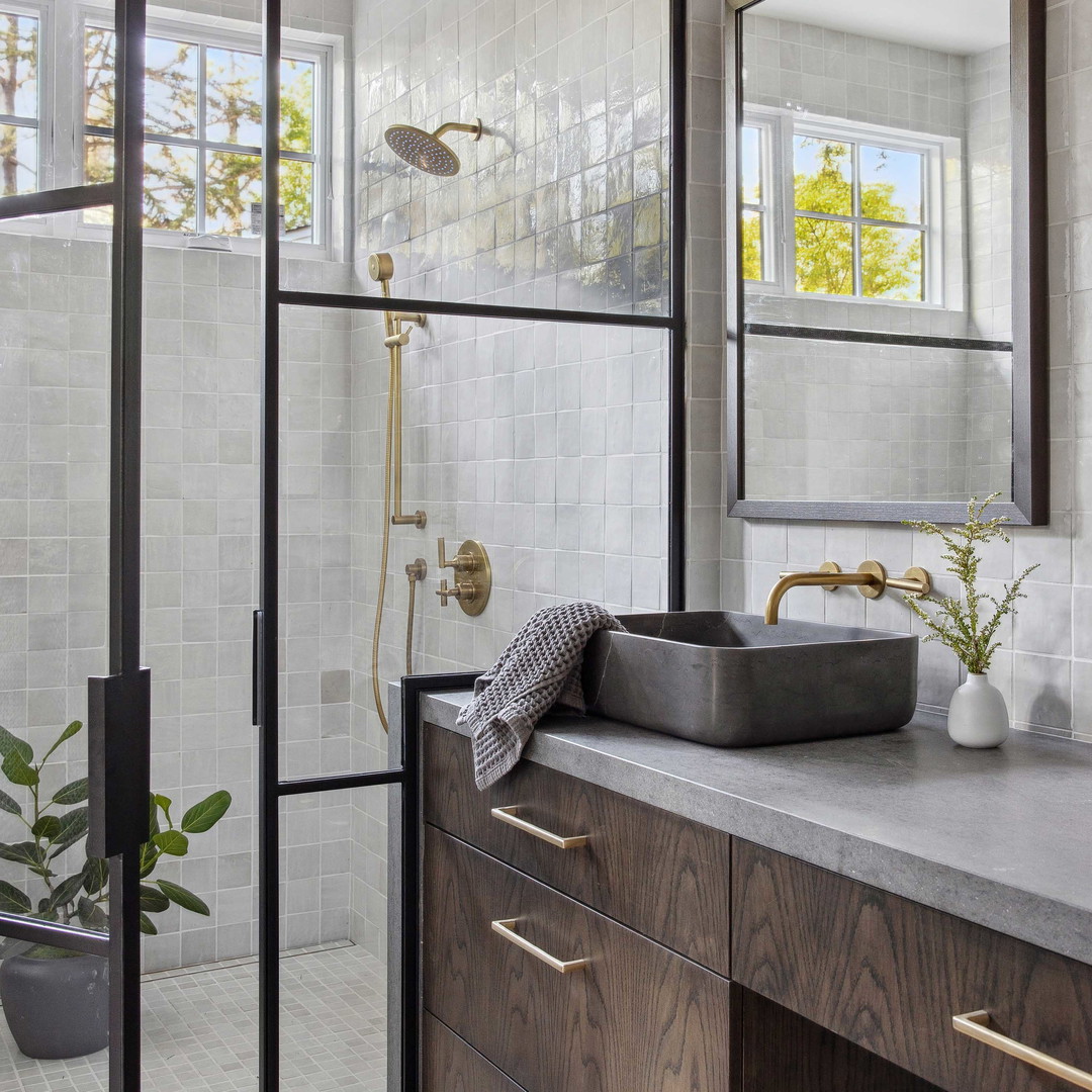 a bathroom with a sink, mirror, and shower