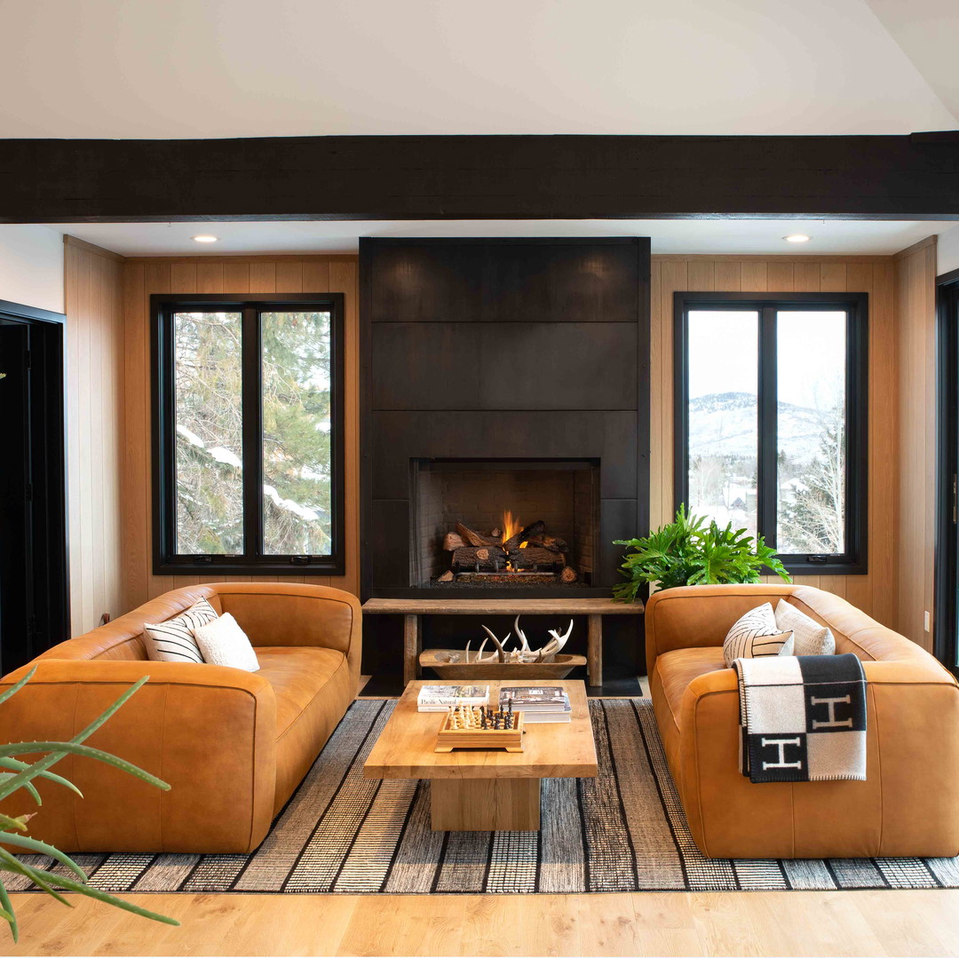 a living room filled with furniture and a fire place