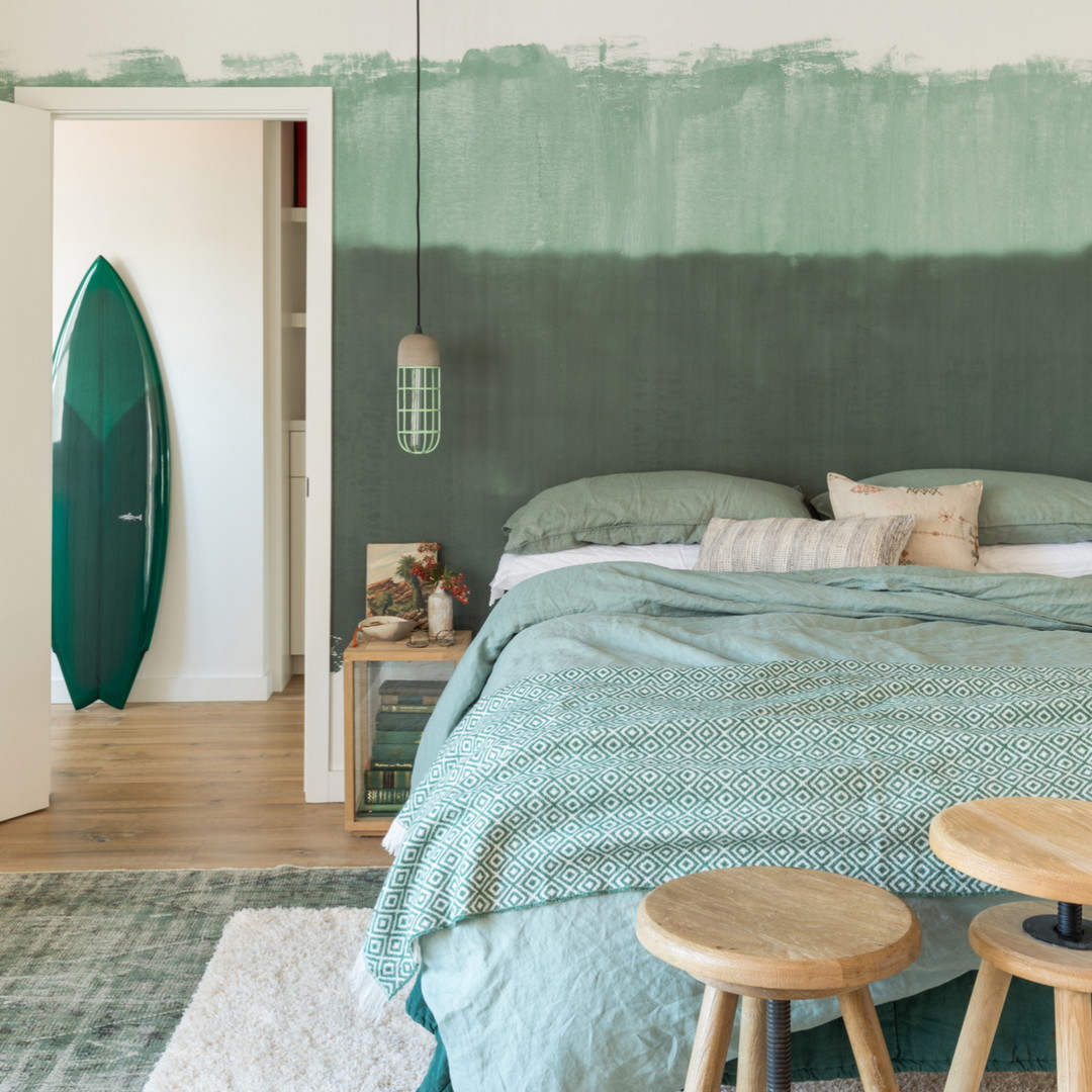 a bedroom with a surfboard painted on the wall