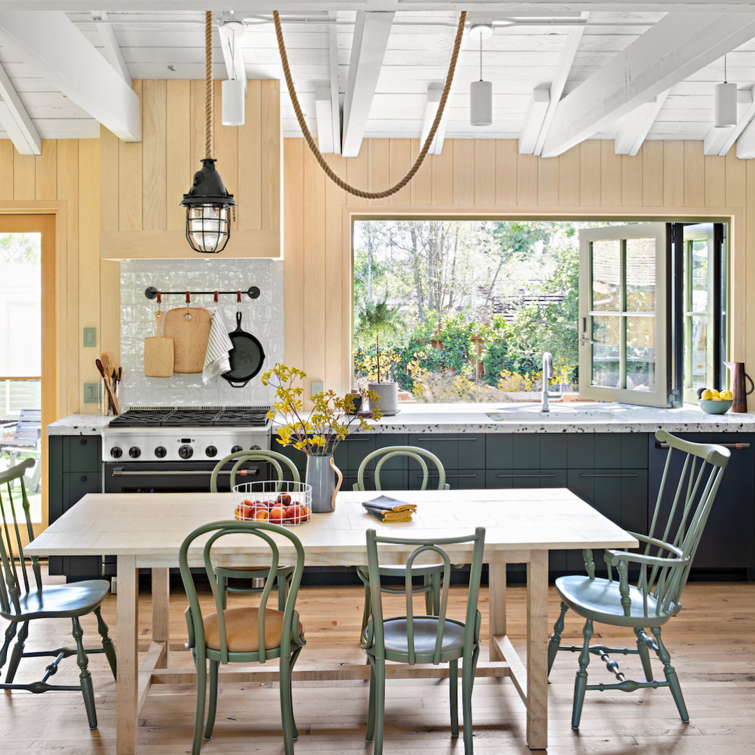 a kitchen with a table, chairs and a stove