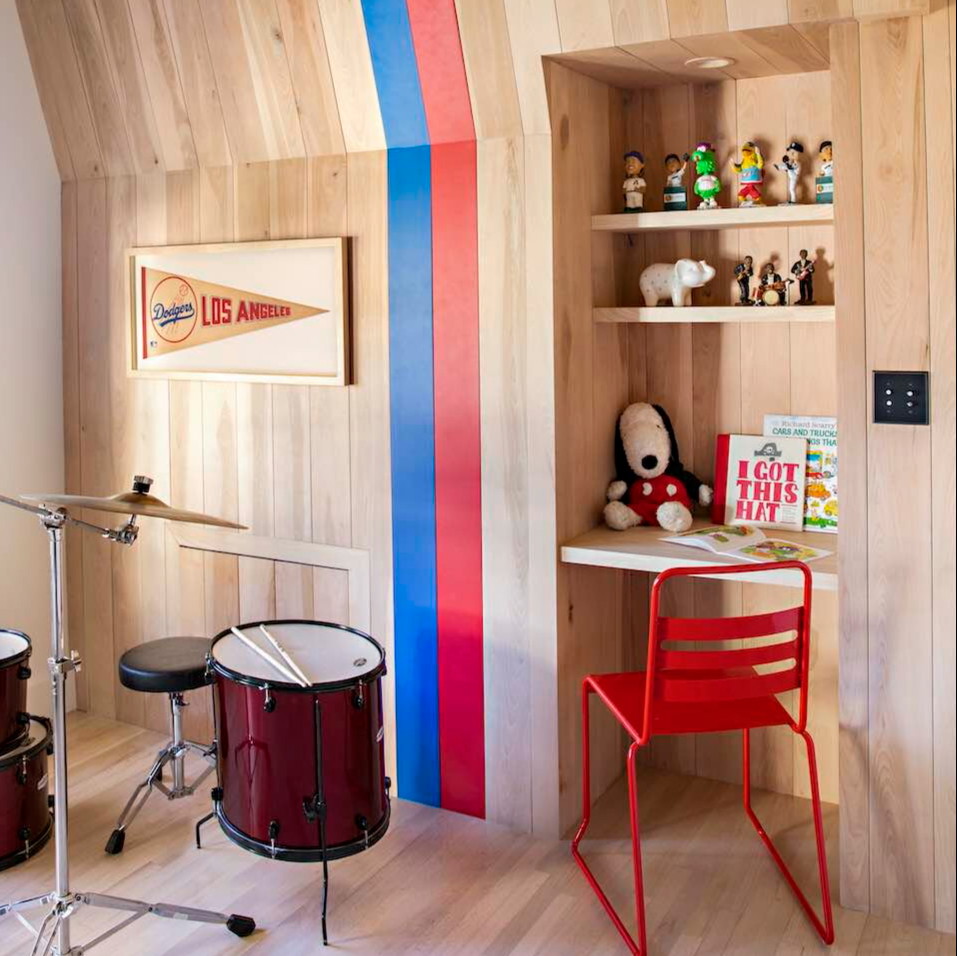 a room with a red chair and a red drum set