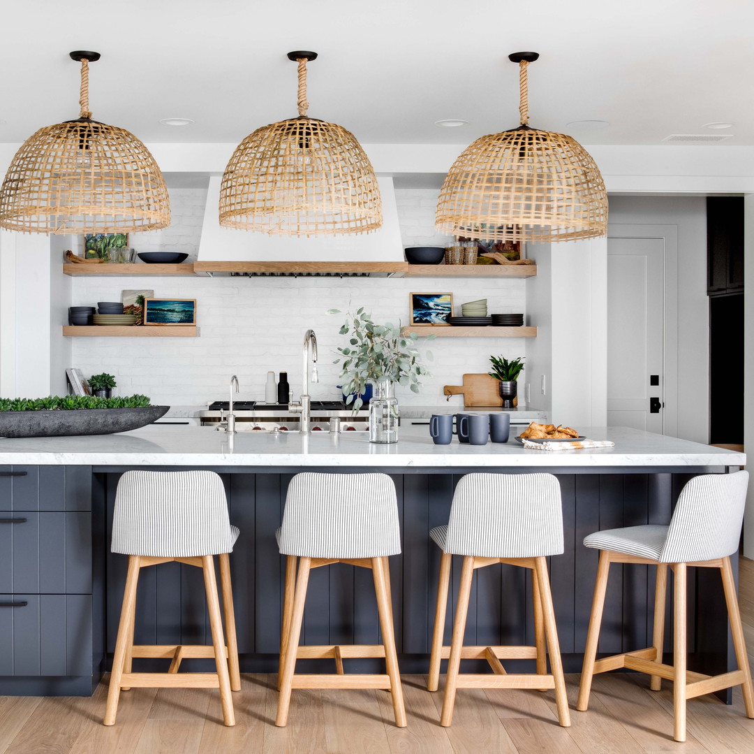 a kitchen island with four stools in front of it