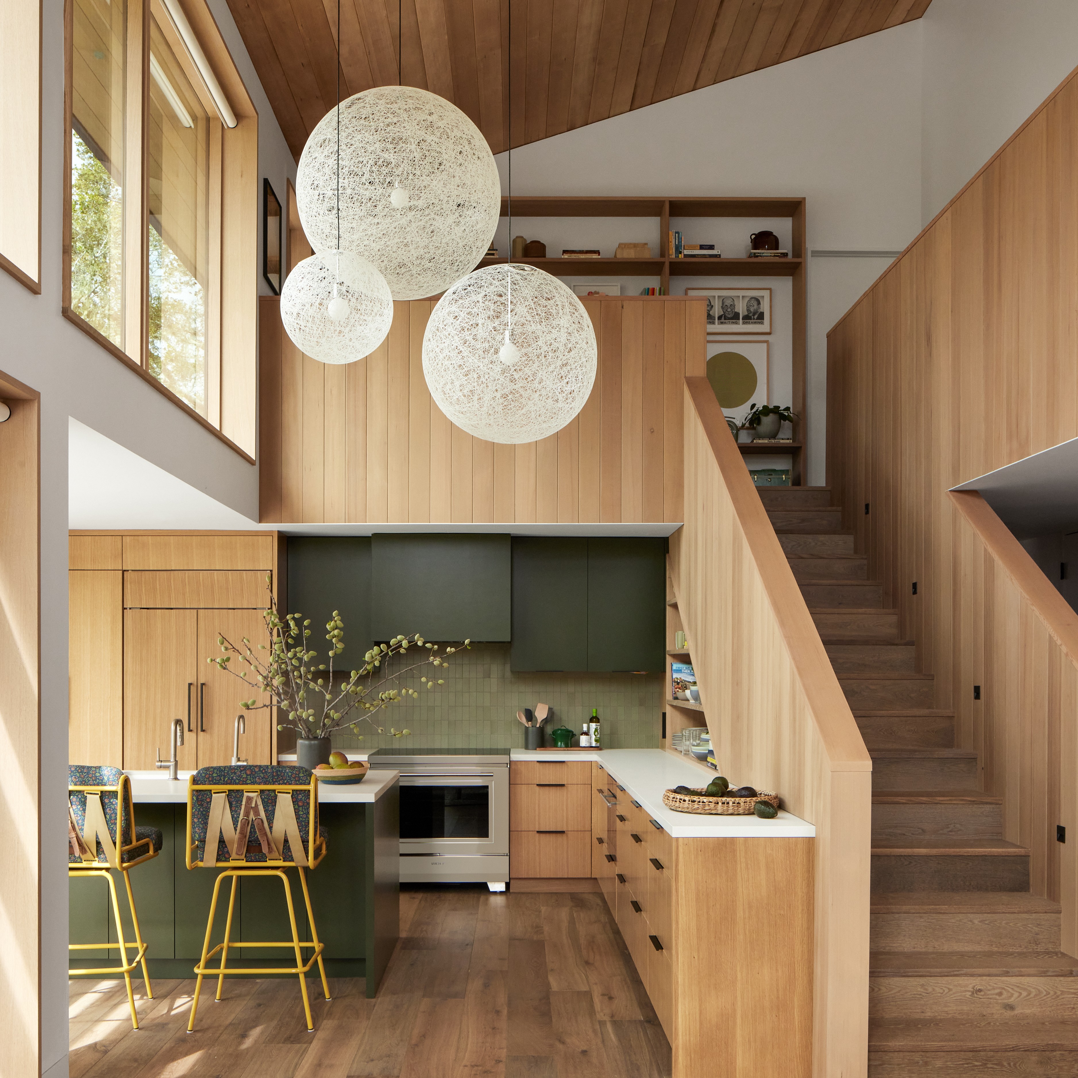 a kitchen with wooden floors and a staircase