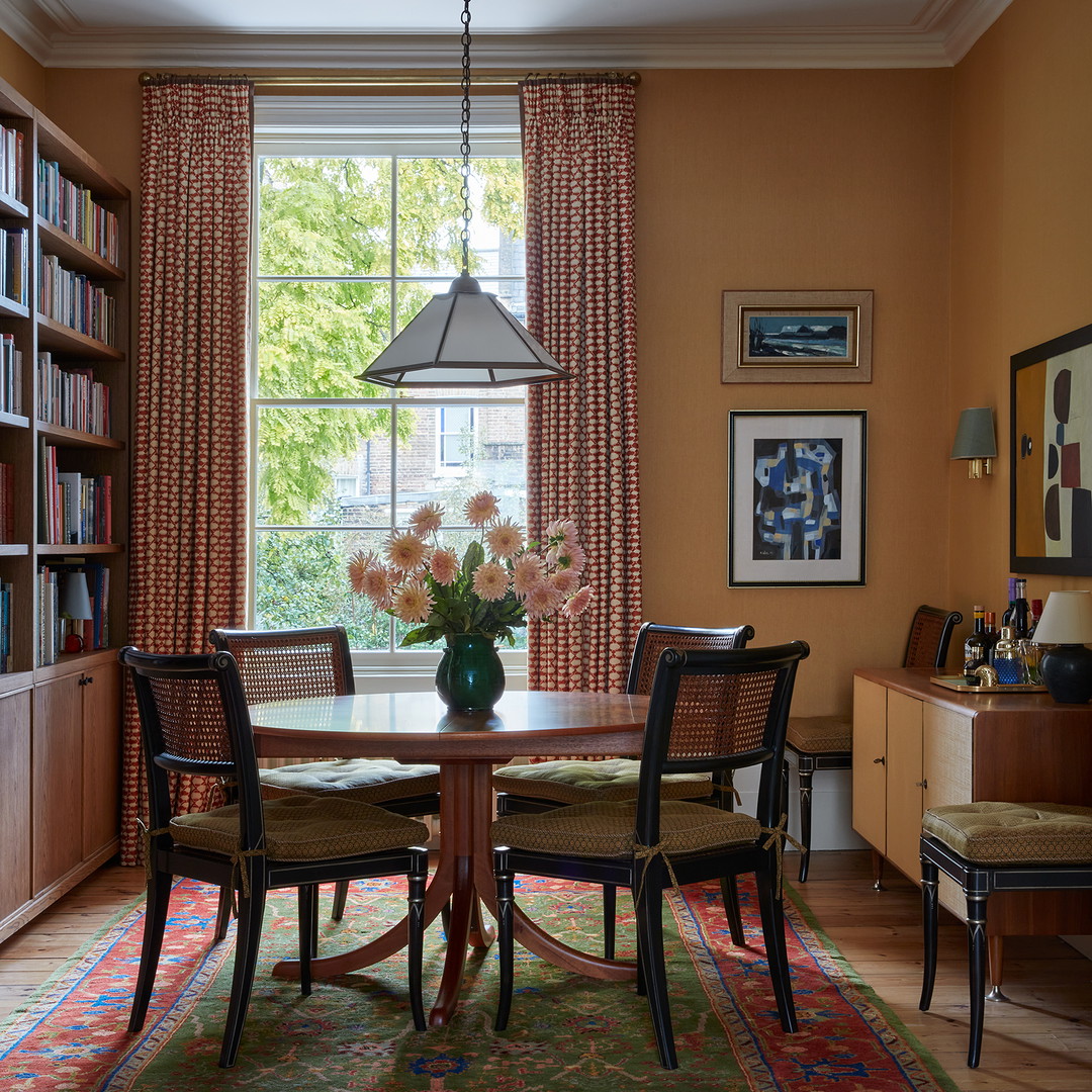 a dining room with a table and chairs