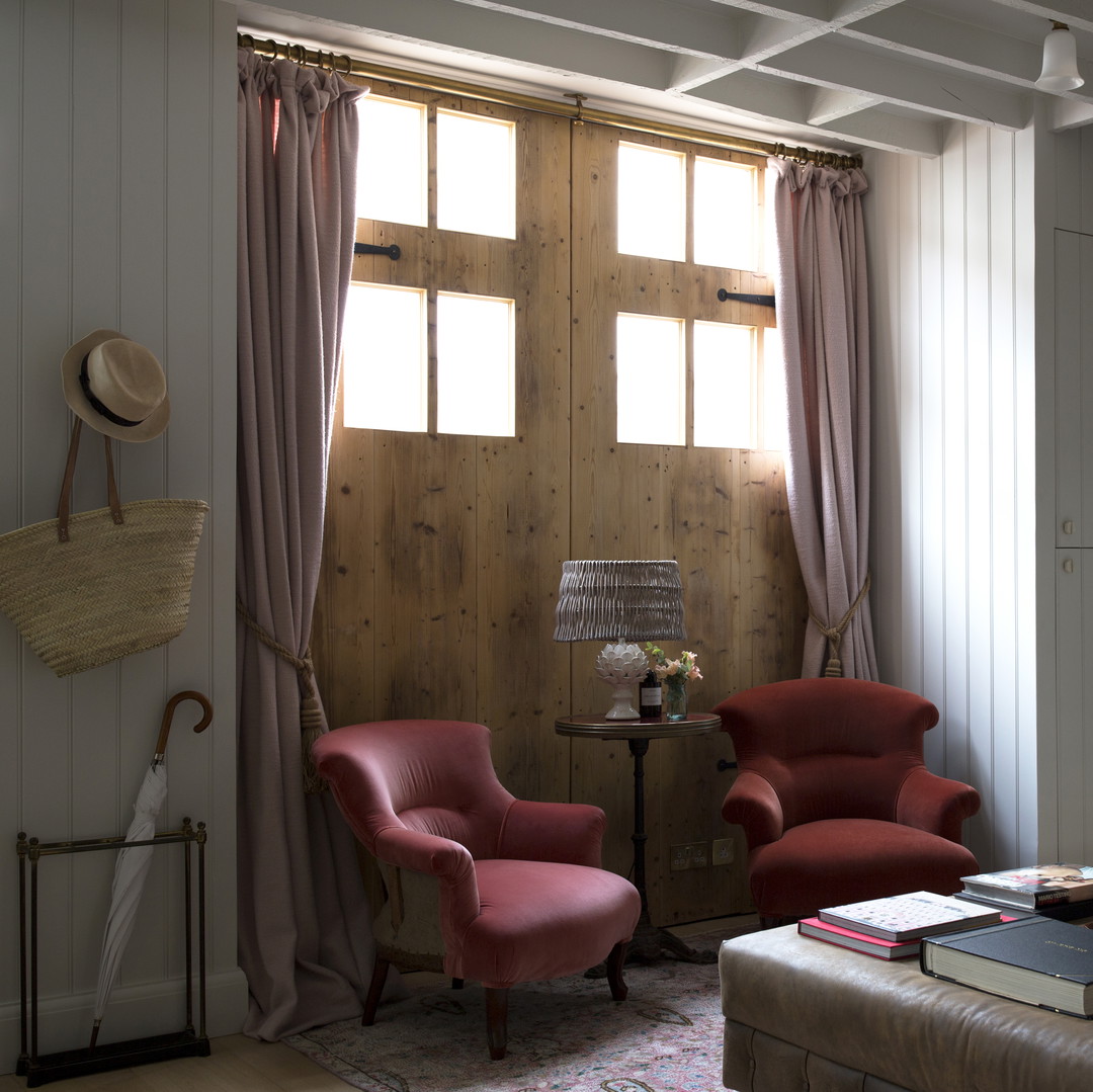 a living room filled with furniture and a window