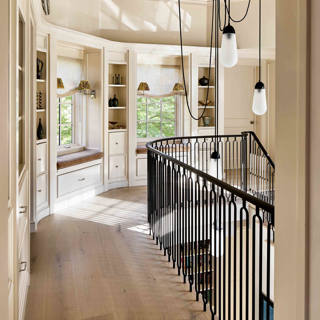 a hallway with a spiral staircase and a window