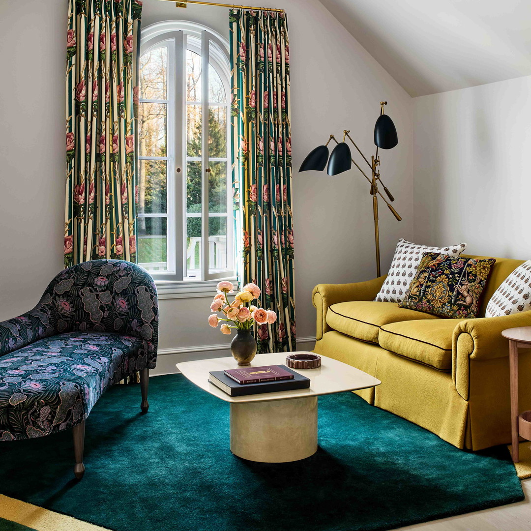 a living room filled with furniture and a large window