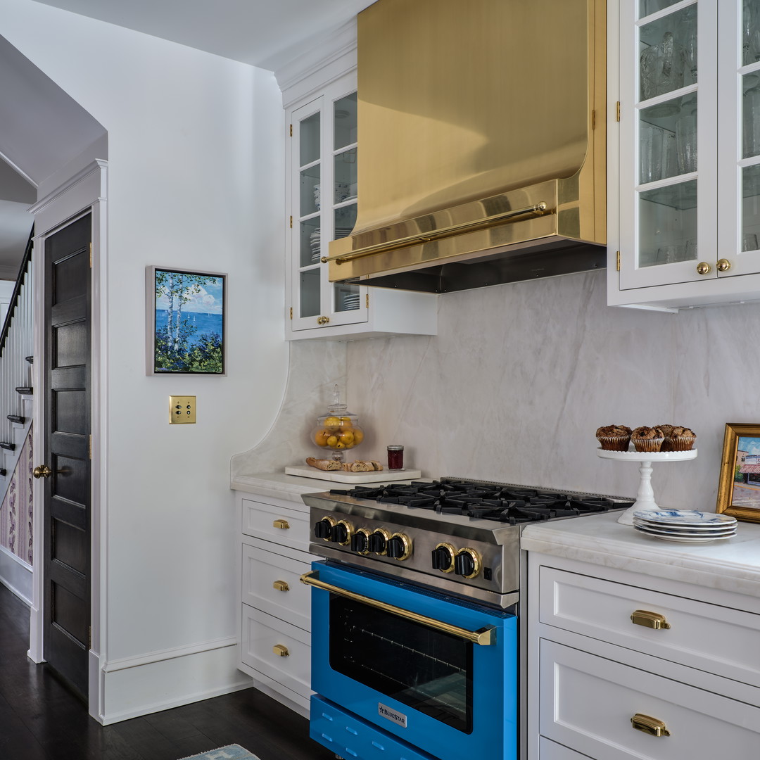 a kitchen with a blue stove and white cabinets