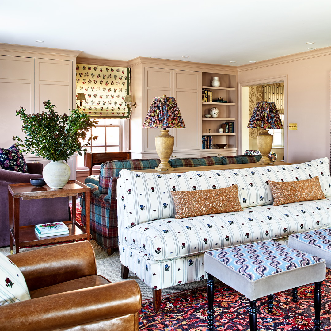 a living room filled with furniture and a colorful rug