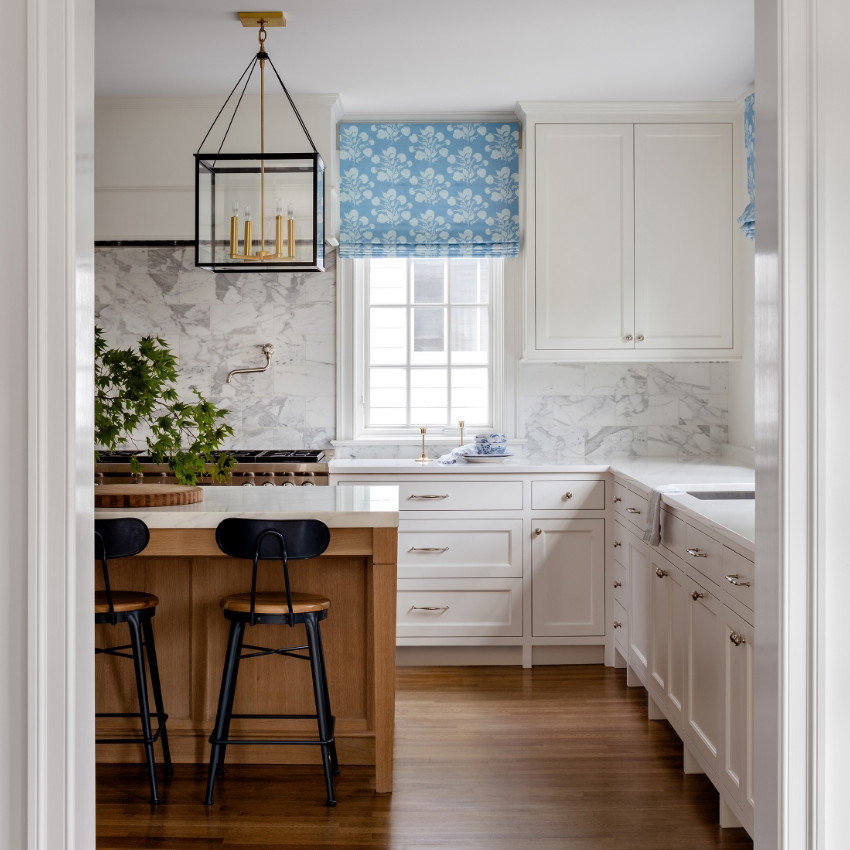 a kitchen with white cabinets and wooden floors