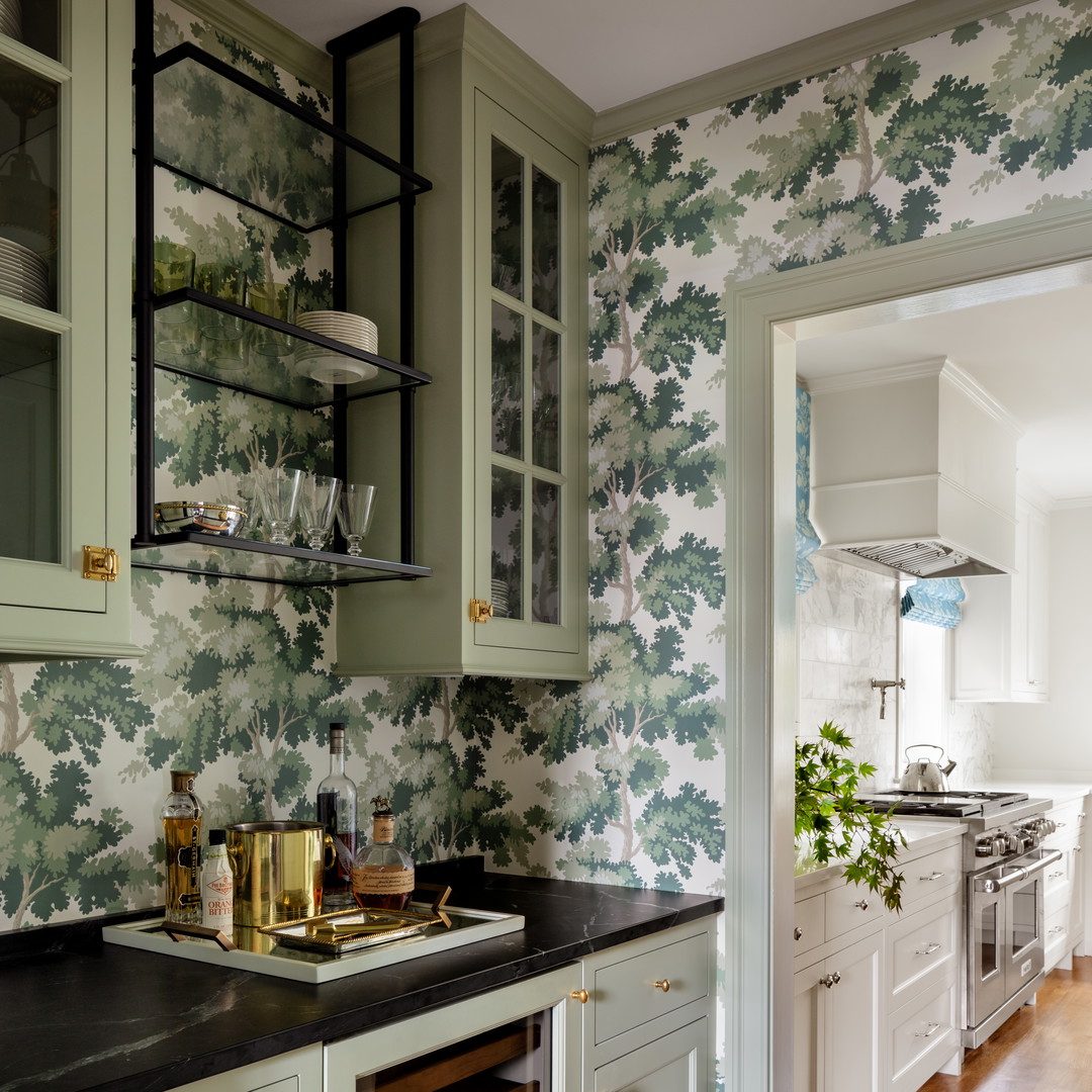 a kitchen with green cabinets and a wooden floor