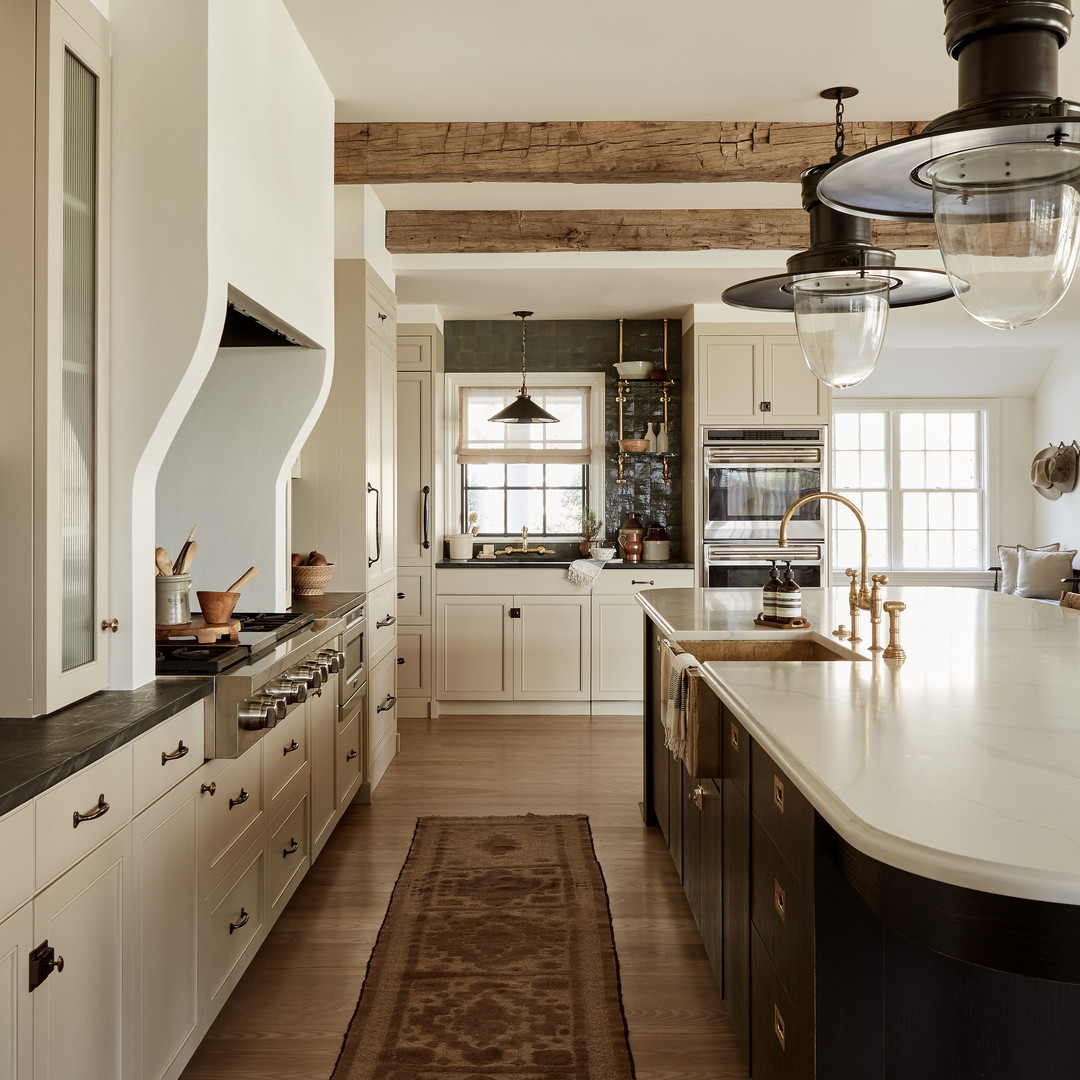 a kitchen with a rug in the middle of the floor