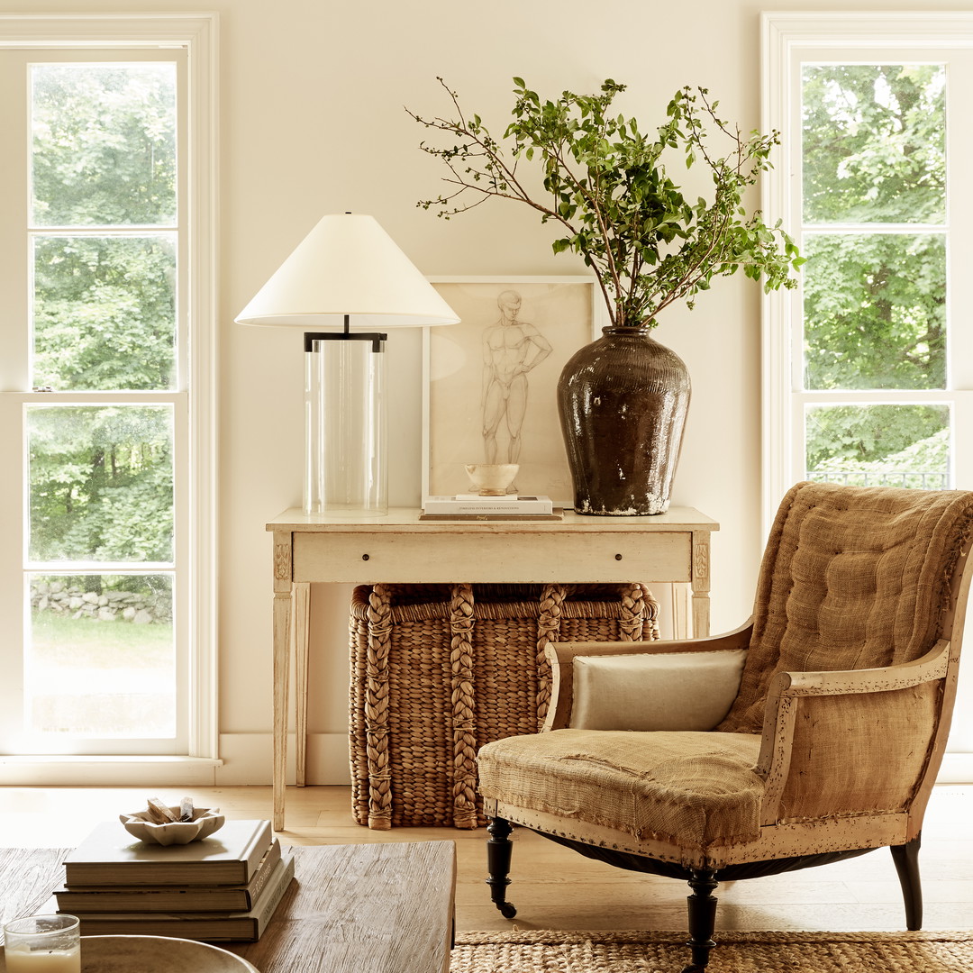 a living room filled with furniture and a lamp