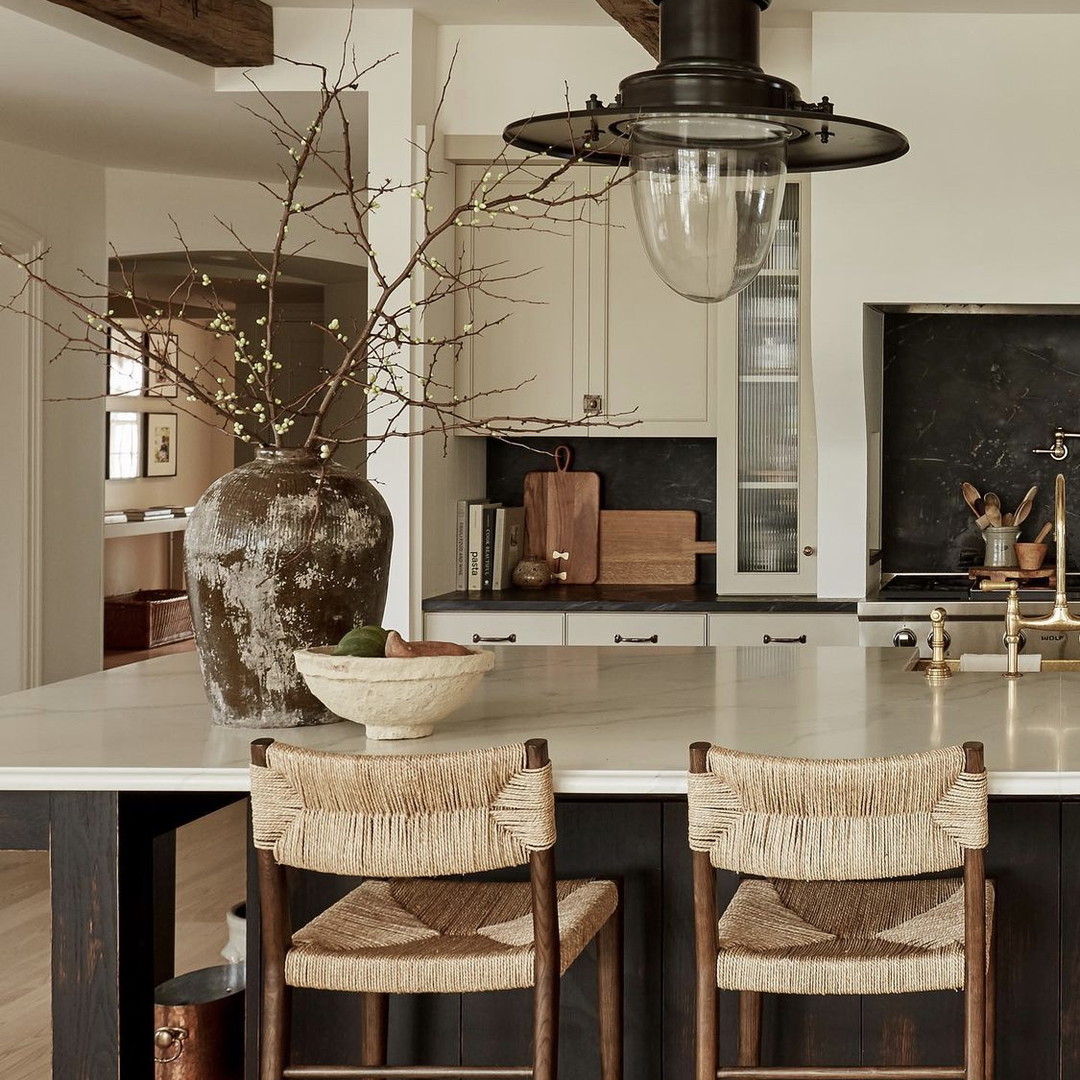 a large kitchen with a center island and chairs