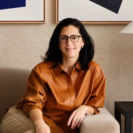 a woman sitting on a couch in a living room