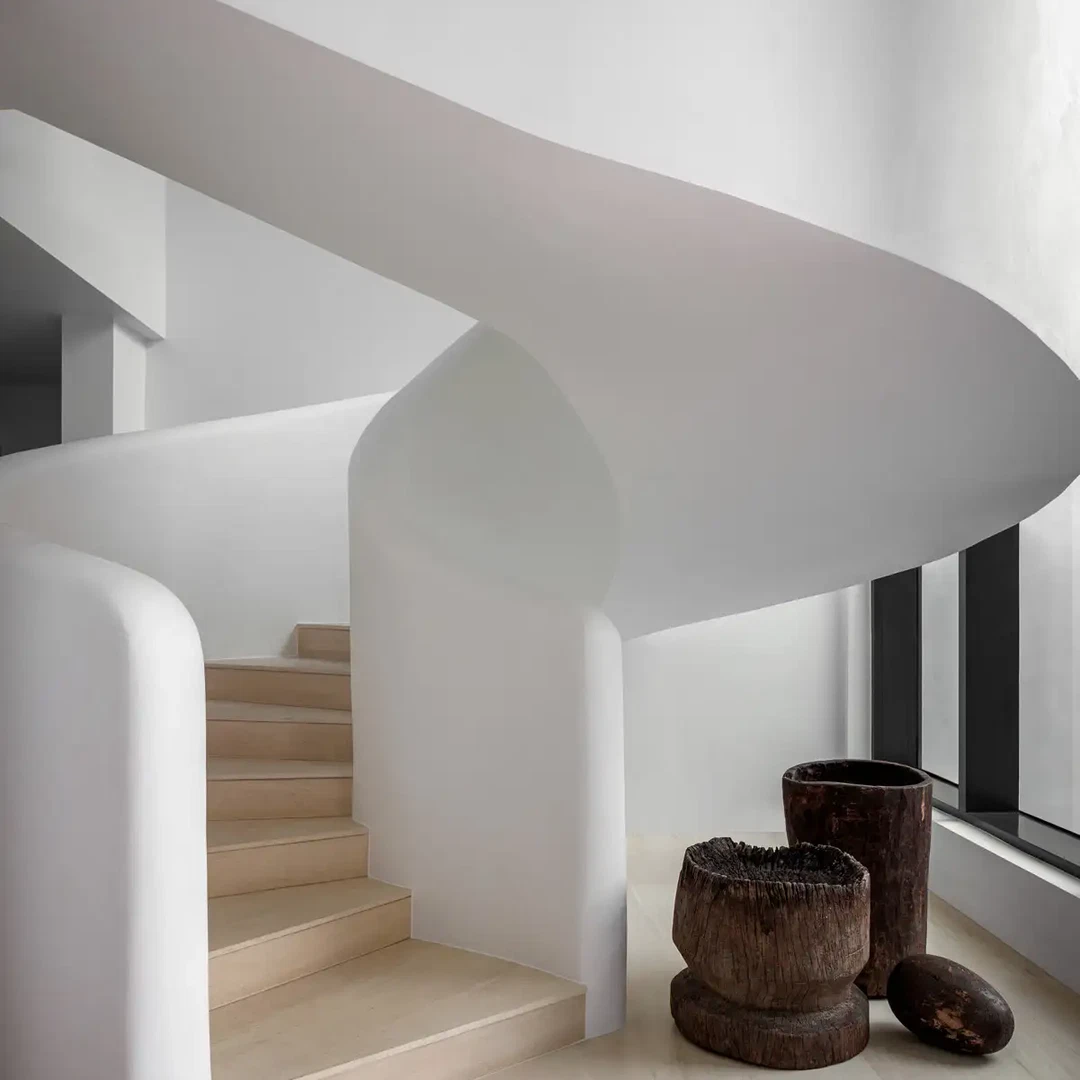 a white room with a spiral stair case