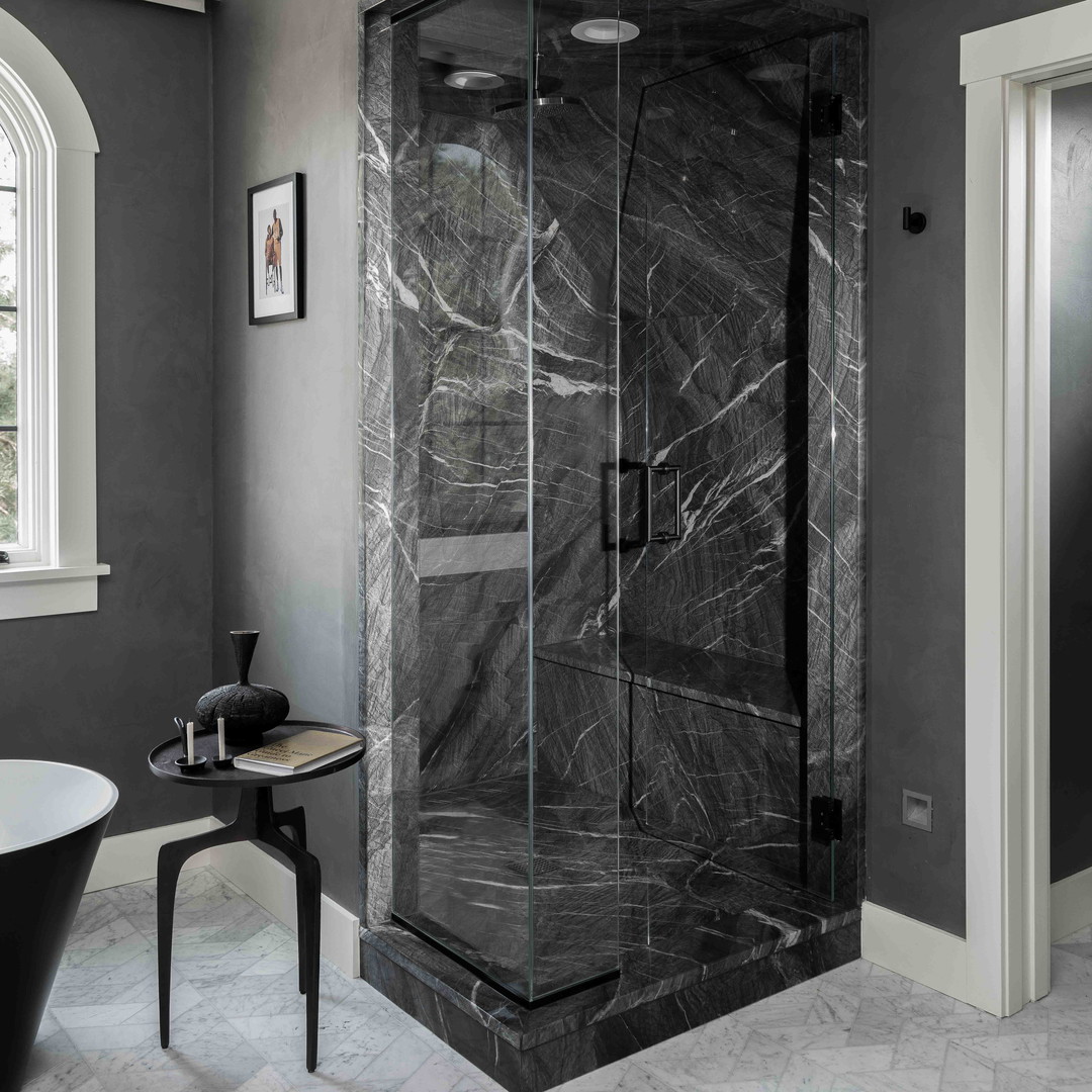 a black and white bathroom with a walk in shower