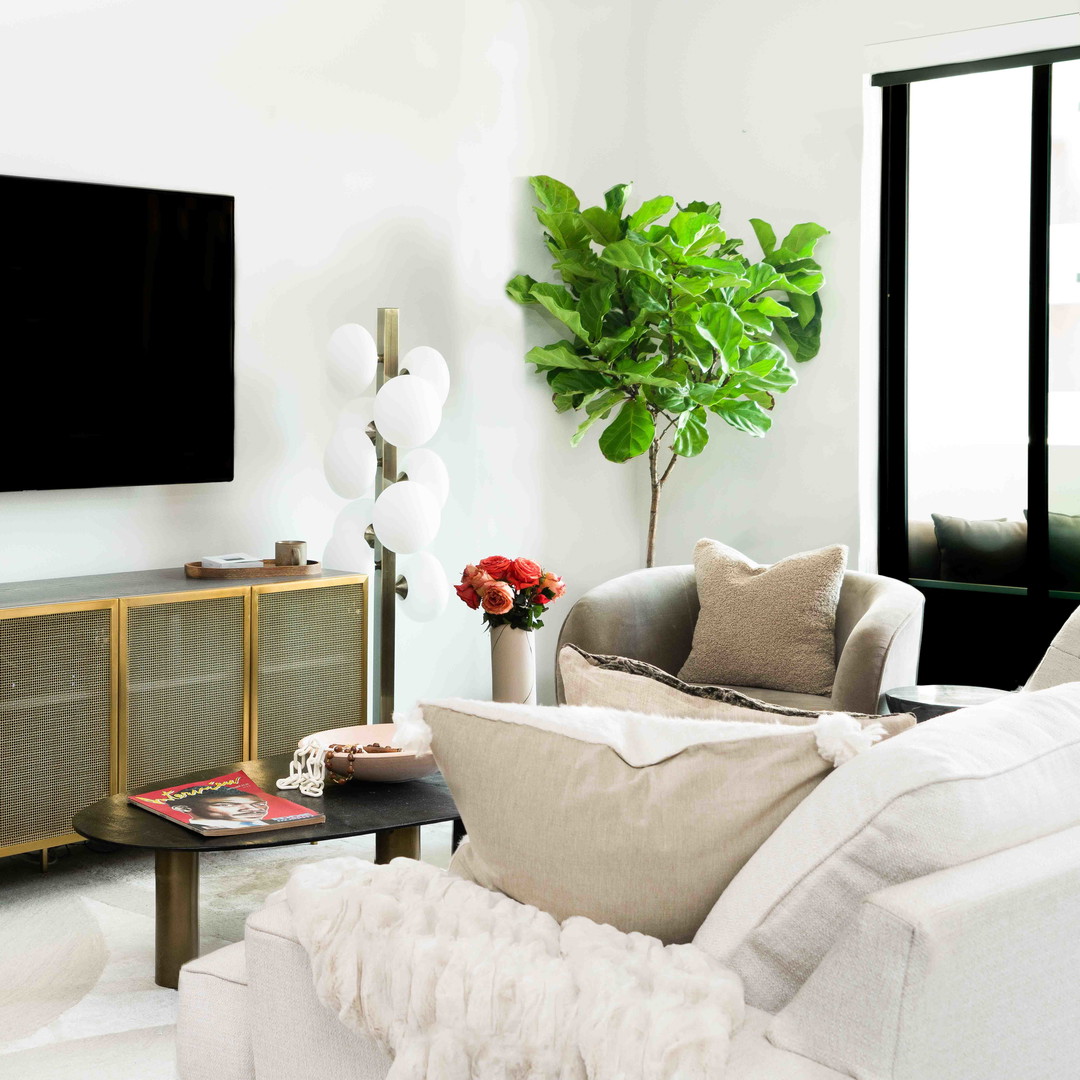 a living room filled with furniture and a flat screen tv