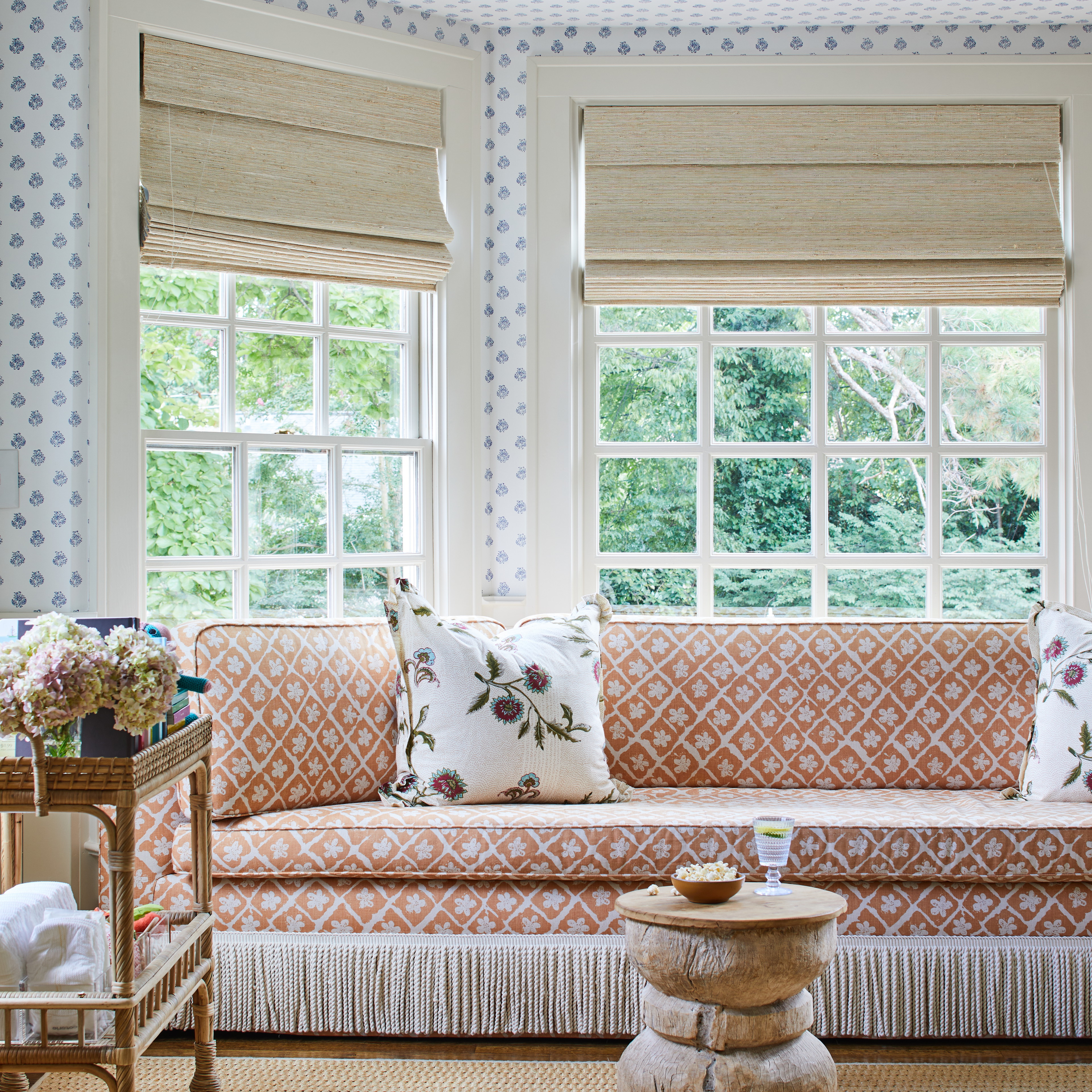 a living room filled with furniture and windows