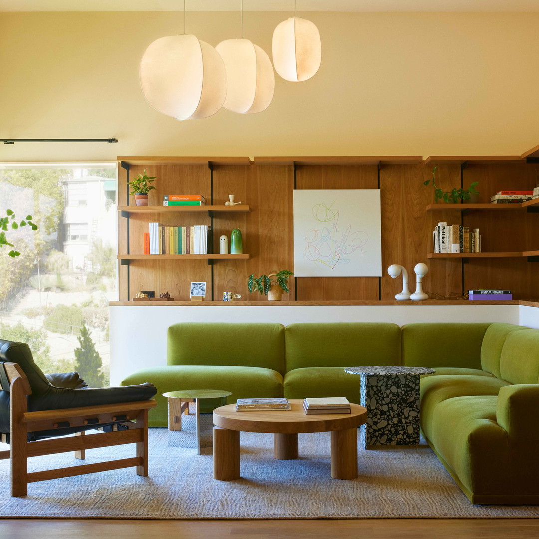 a living room filled with furniture and a large window