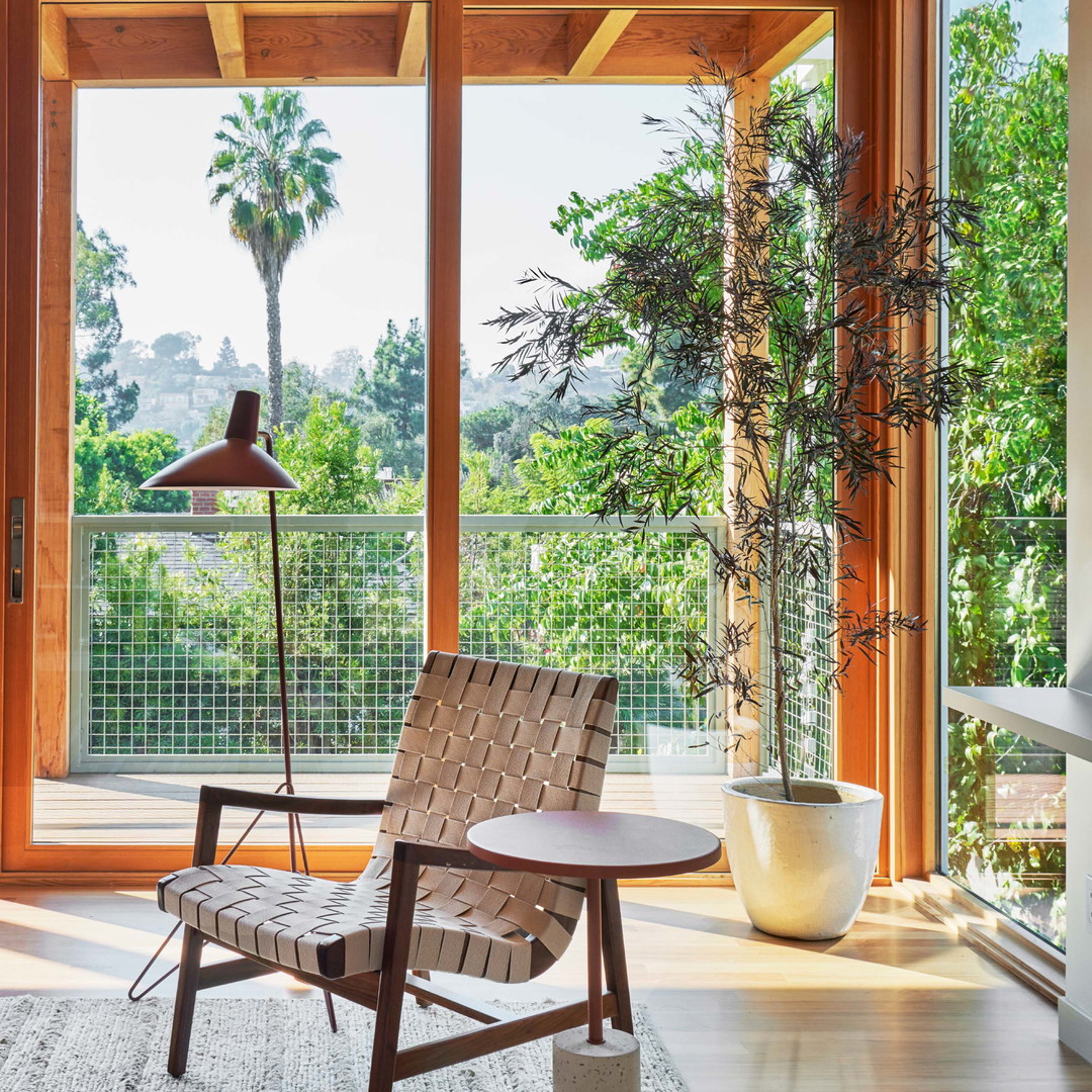 a chair and table in a room with large windows