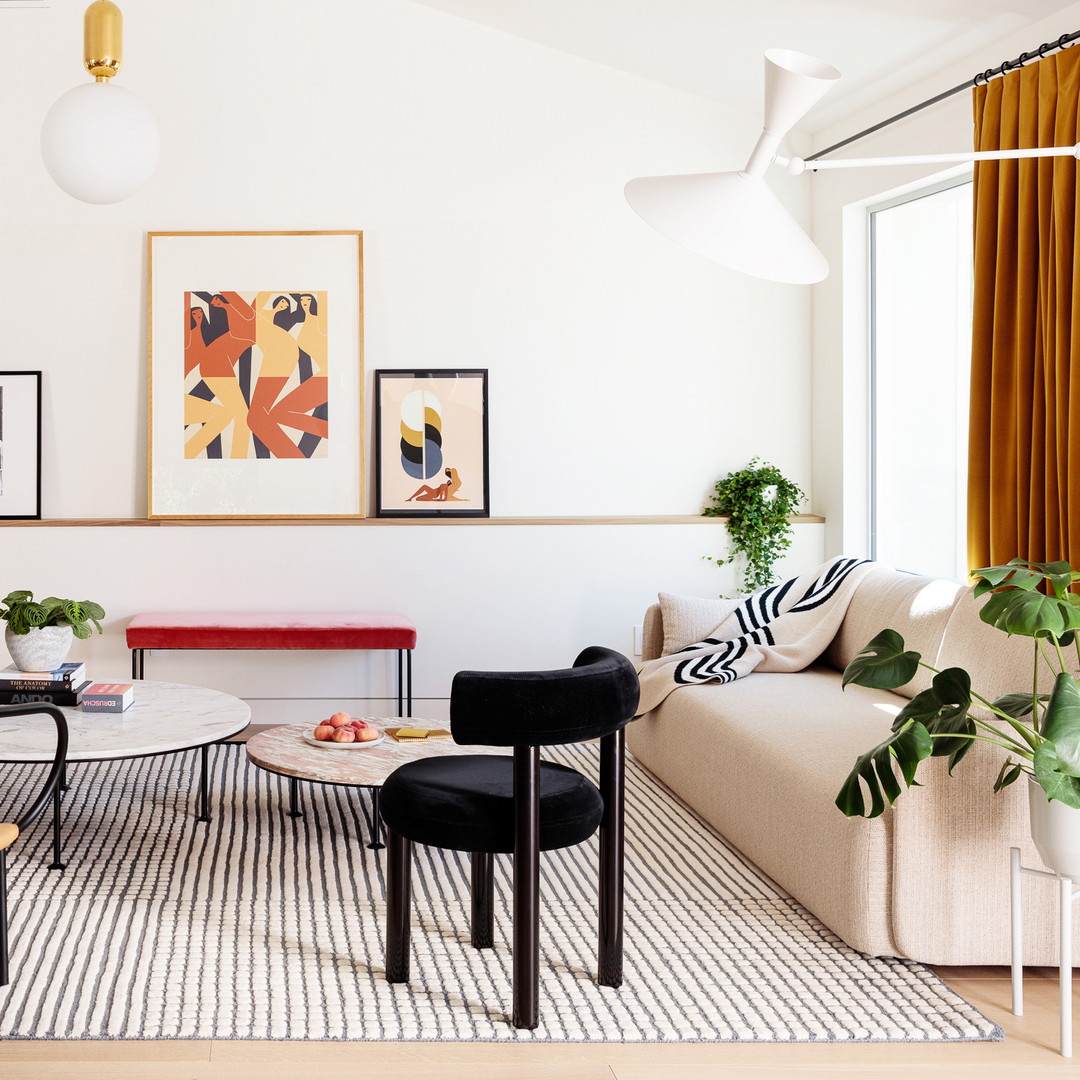 a living room filled with furniture and a painting on the wall