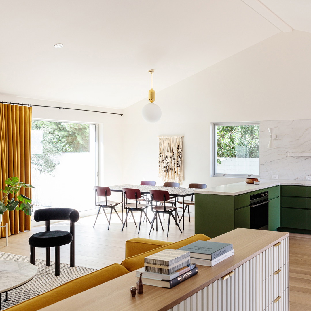 a living room filled with furniture and a dining room table