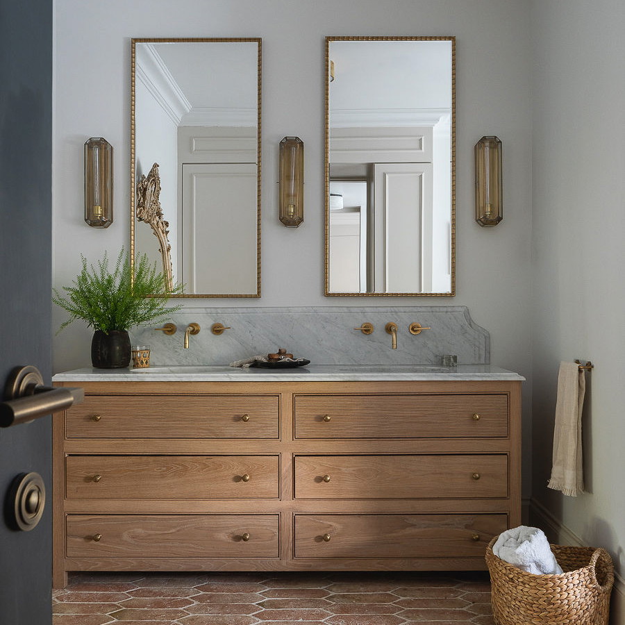 a bathroom with two mirrors and two sinks