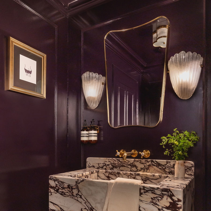 a bathroom with a marble sink and a mirror