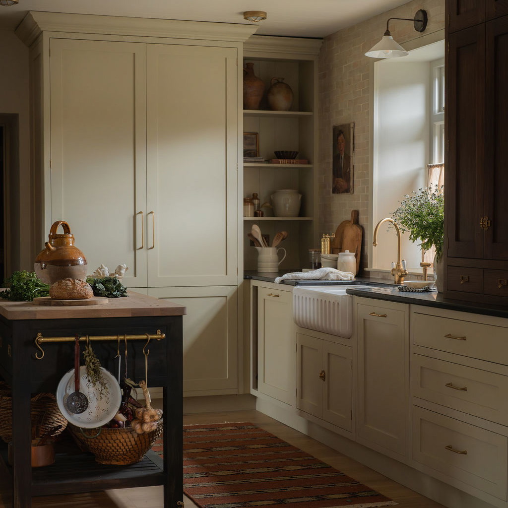 a kitchen filled with lots of white cabinets