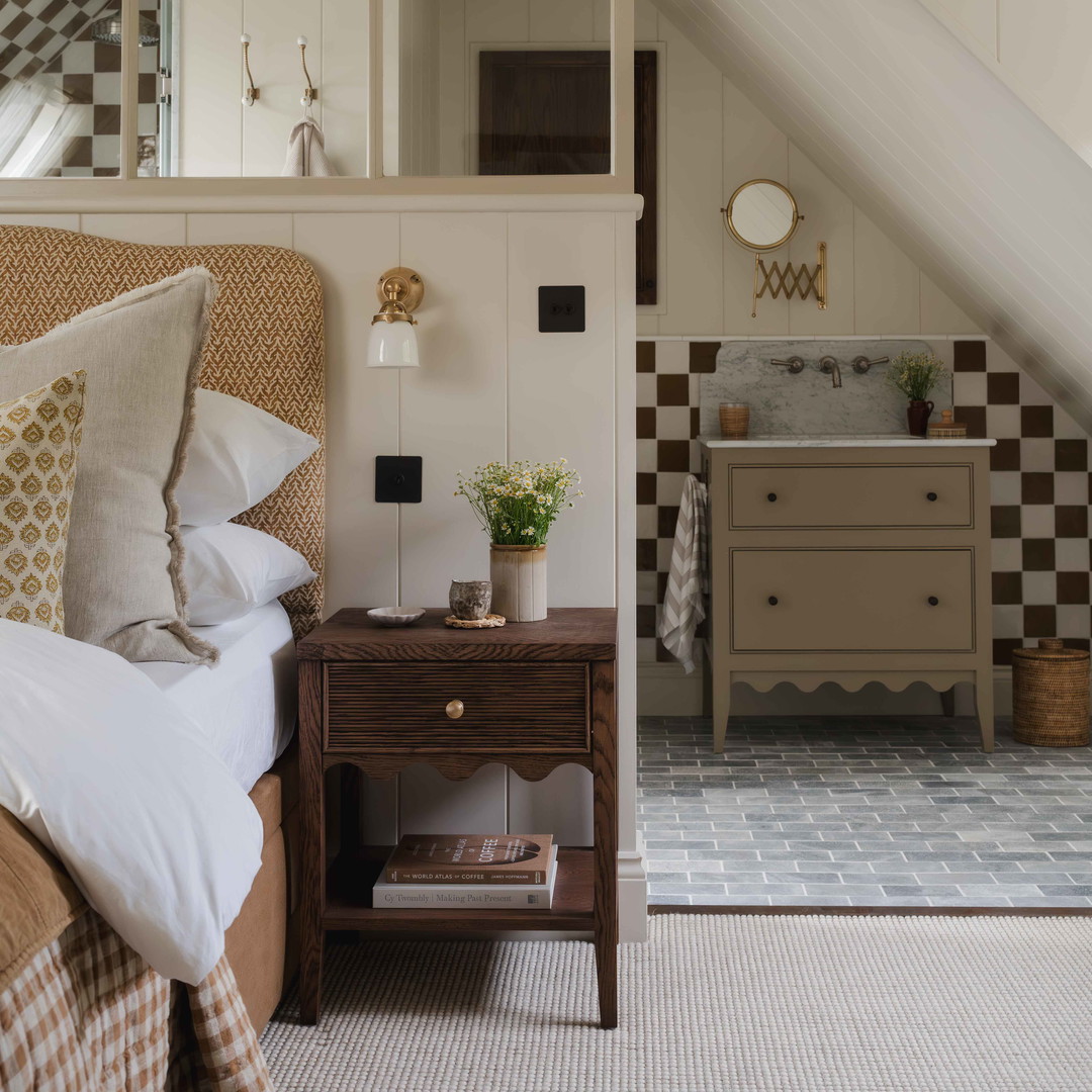 a bed sitting under a window next to a dresser