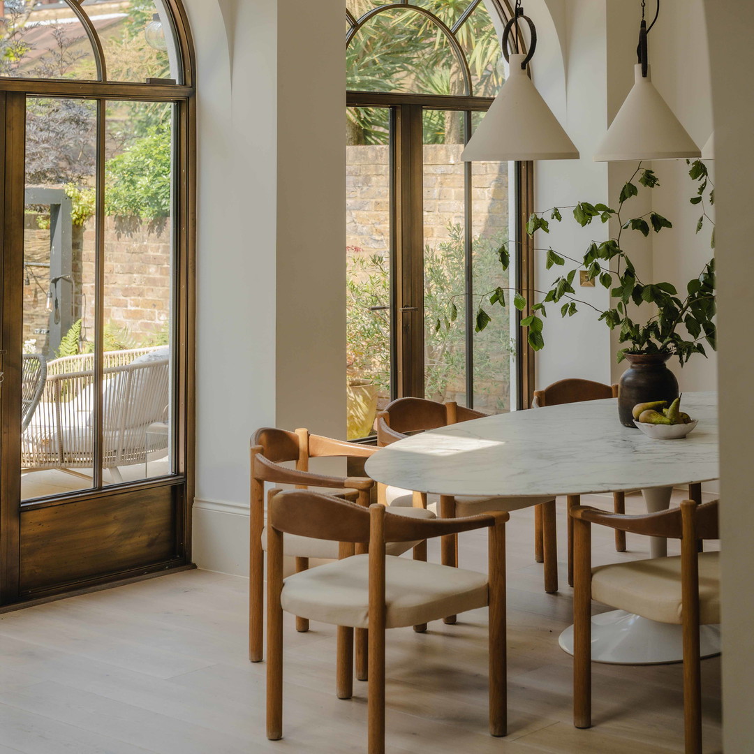 a dining room with a table and chairs