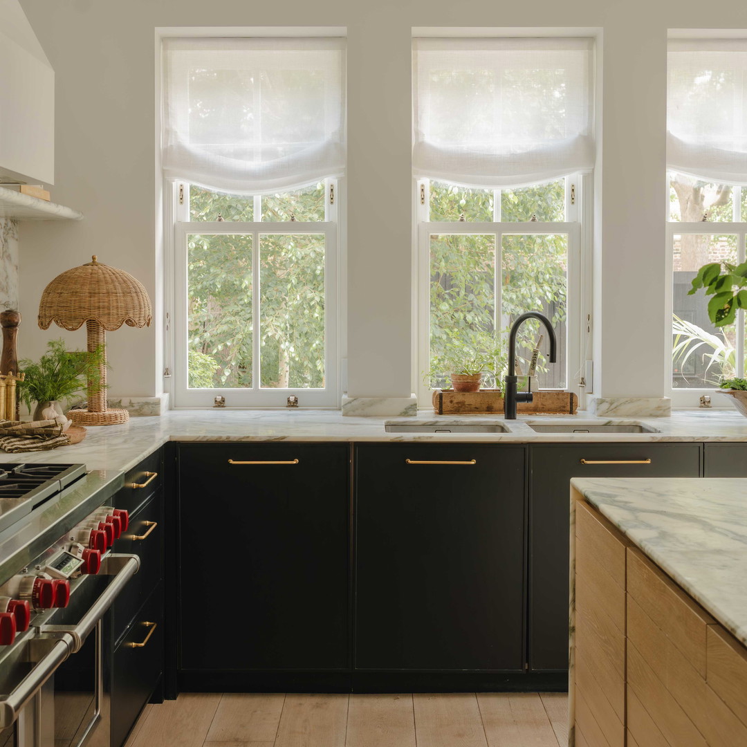 a kitchen with a sink, stove, and a window