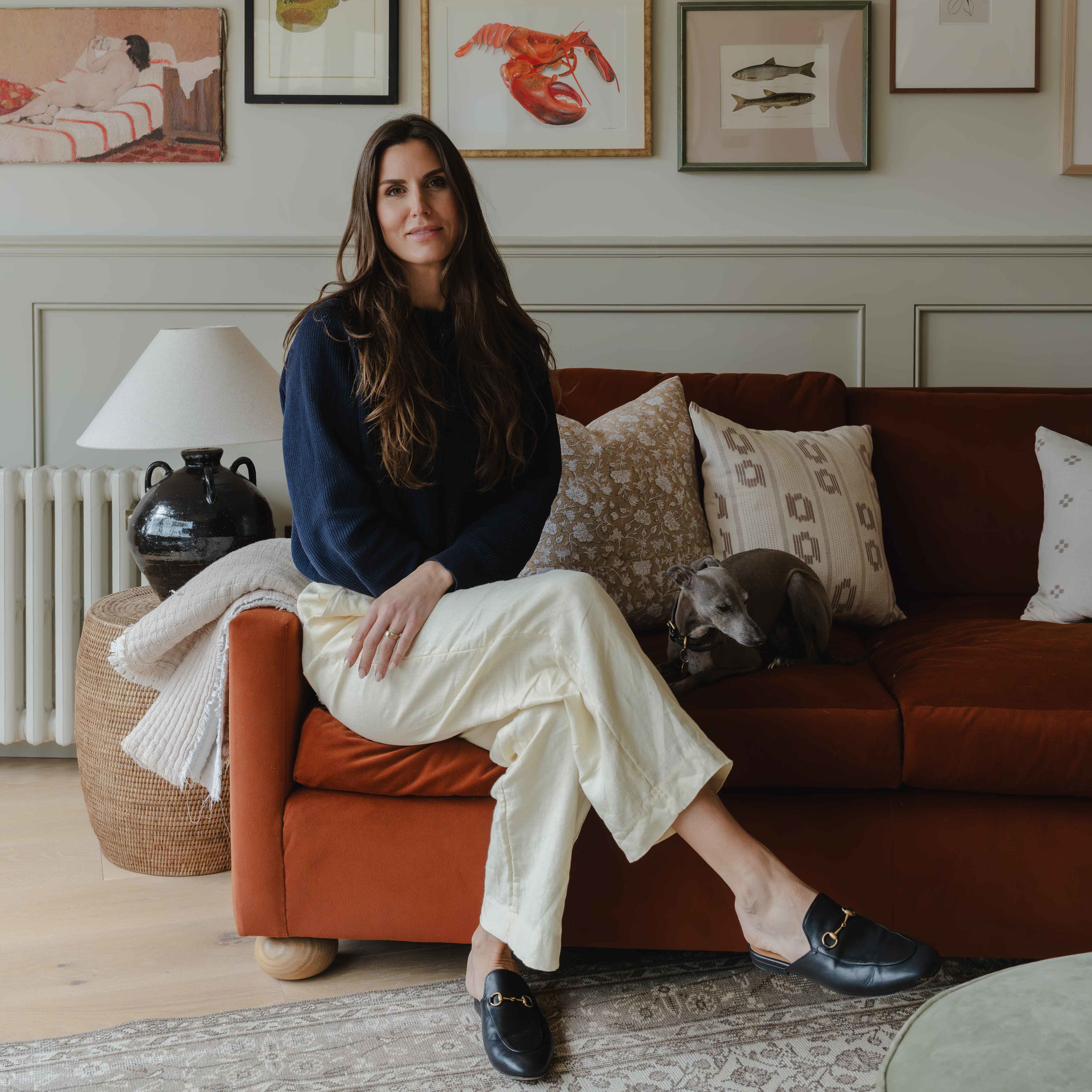 a woman sitting on a couch in a living room