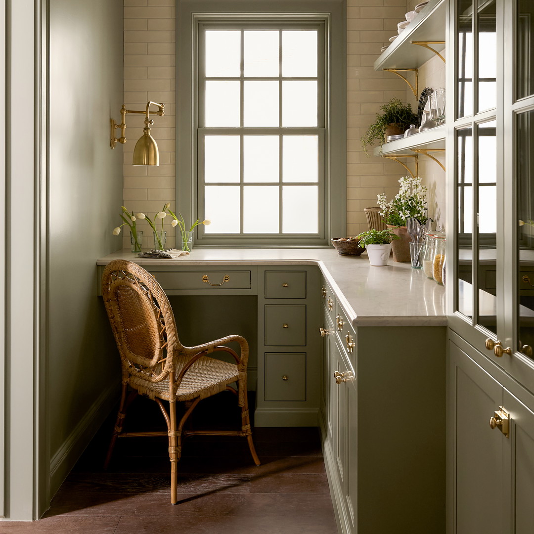 a chair sitting in a kitchen next to a window